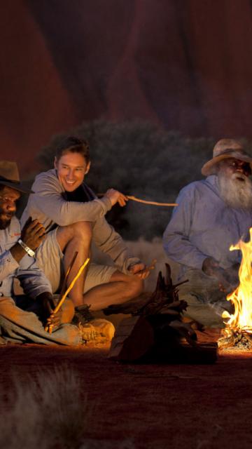 Sitting around a campfire at night
